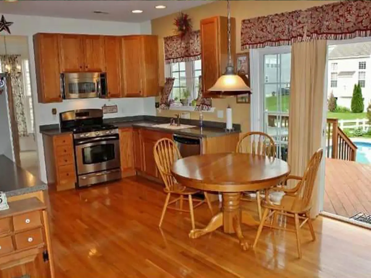 Traditional kitchen design with oak cabinetry and dining space.